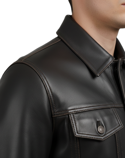 Leathino dark brown genuine cowhide leather trucker jacket with button closure and contrast stitching.
Men’s premium dark brown leather jacket with shirt collar and flap pockets by Leathino
Close-up of handcrafted dark brown leather texture and vintage metal buttons on Leathino jacket
Front view of Leathino men’s dark brown leather trucker jacket with structured panels and smooth grain finish